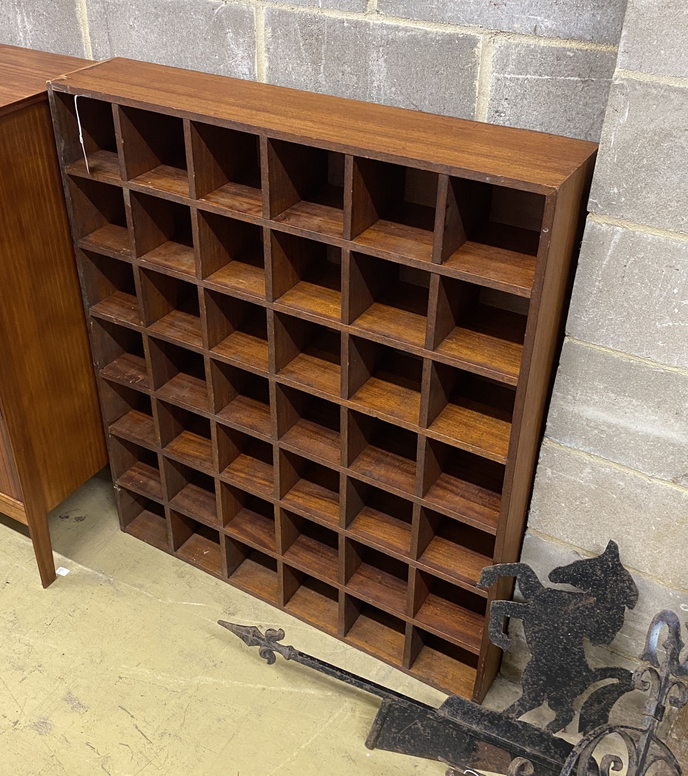 A mahogany pigeonhole wall unit, width 104cm, depth 21cm, height 122cm